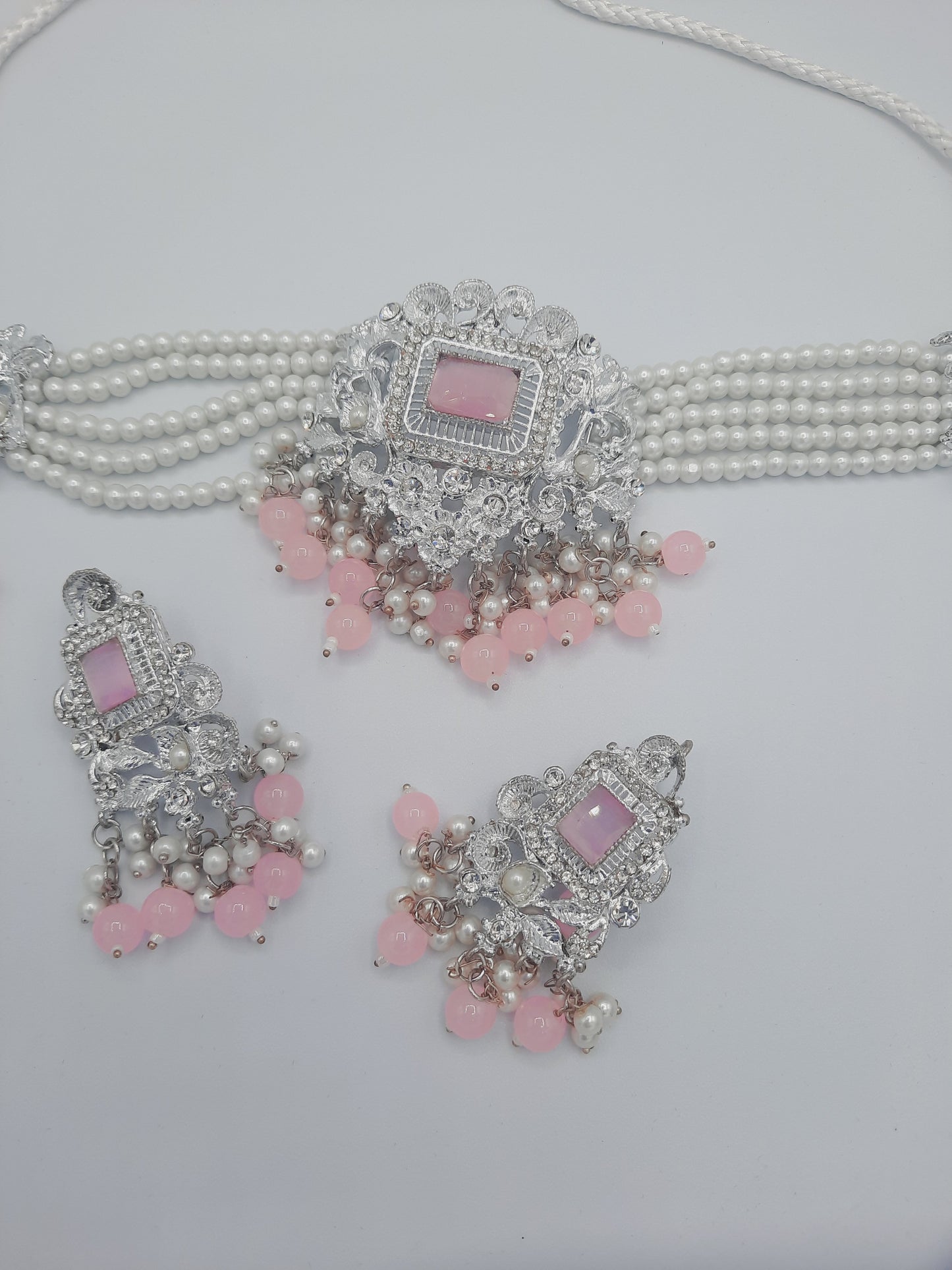 Anarkali Zircon choker set with guluband earrings and teeka in pink color in silver tone - NATASHAHS