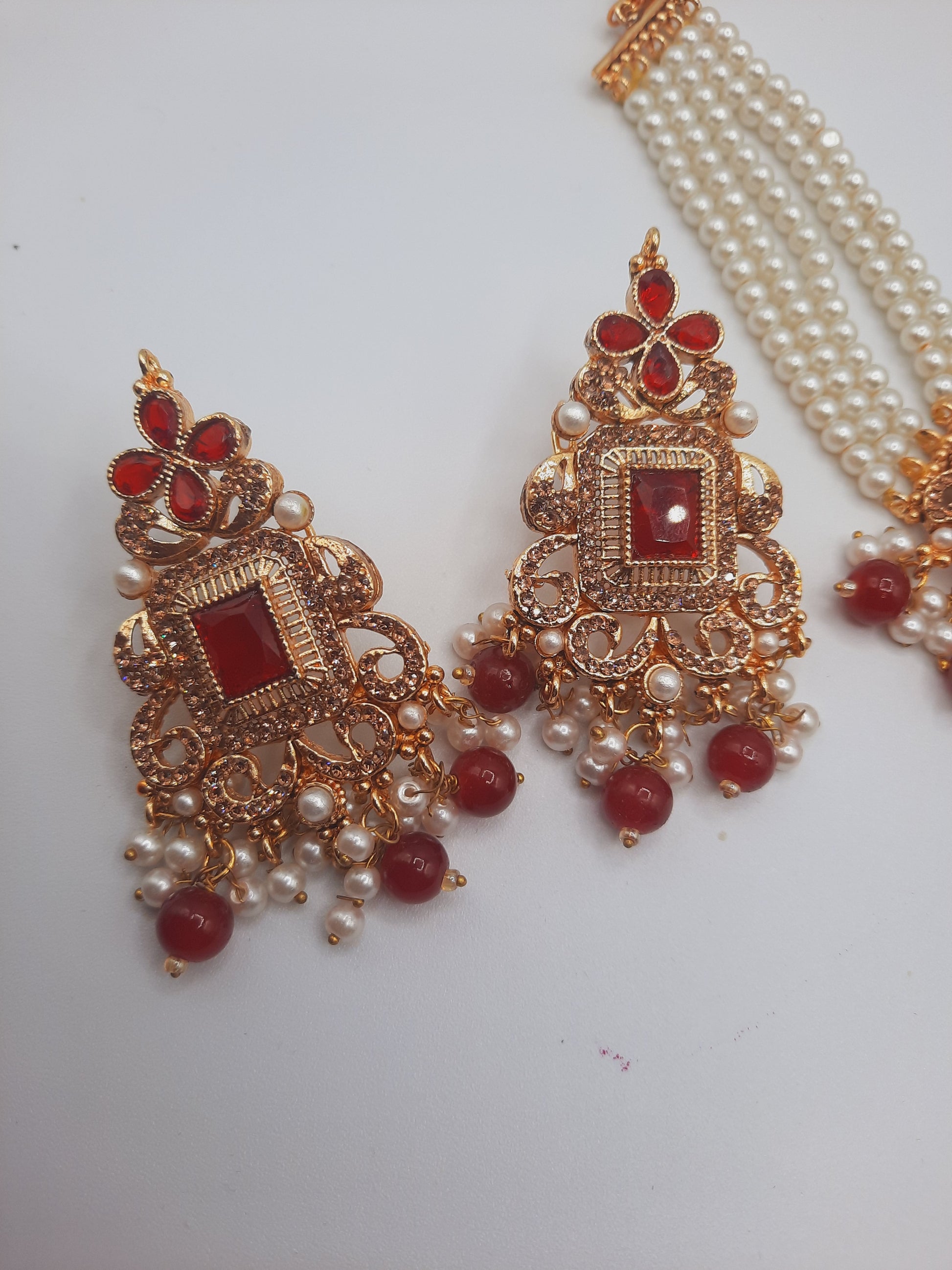 Anarkali choker set with guluband earrings and teeka in red color with gold plated tone - NATASHAHS
