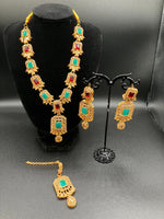 Golden jewelry set in sea green and red stones