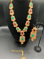 Golden jewelry set in sea green and red stones